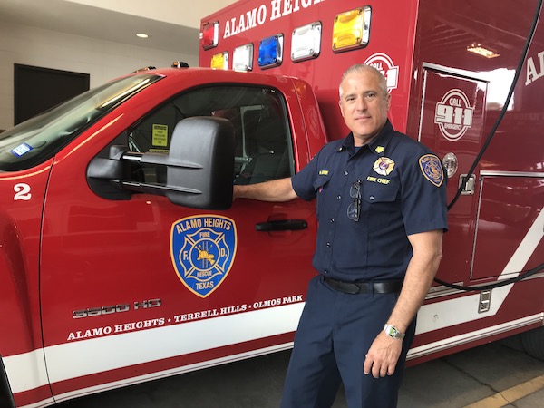 Alamo Heights Fire Chief Michael Gdovin standing in front of firetruck