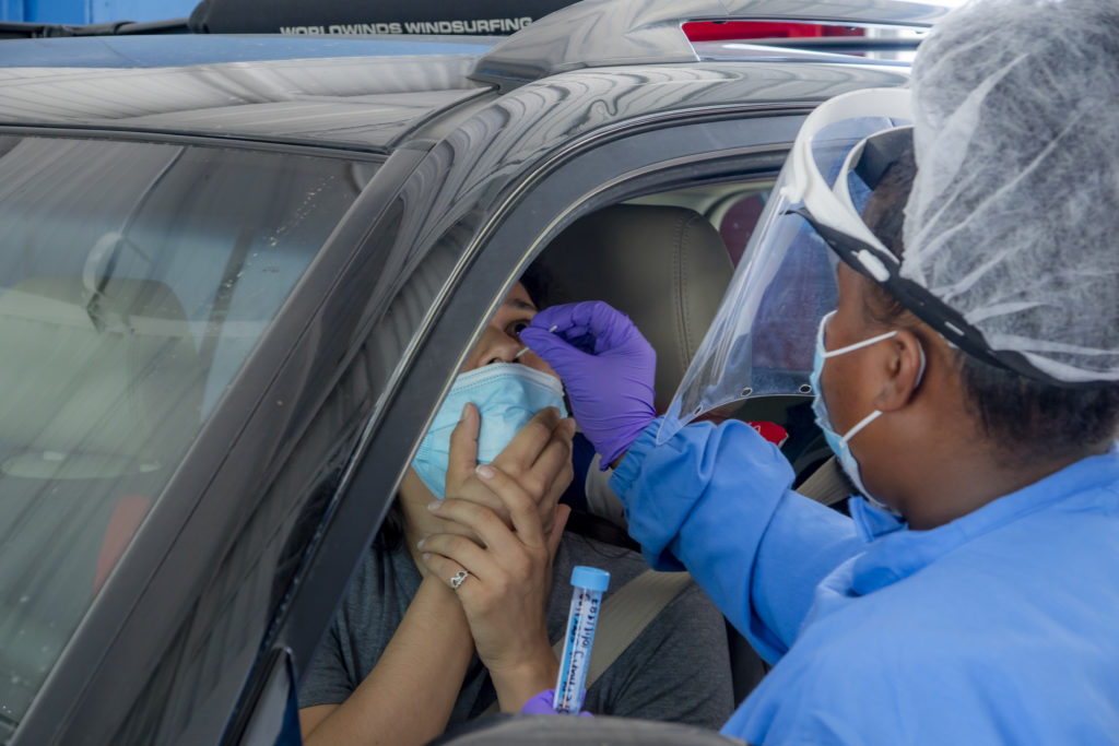 Woman swabbing another woman's nose for a Covid-19 Test