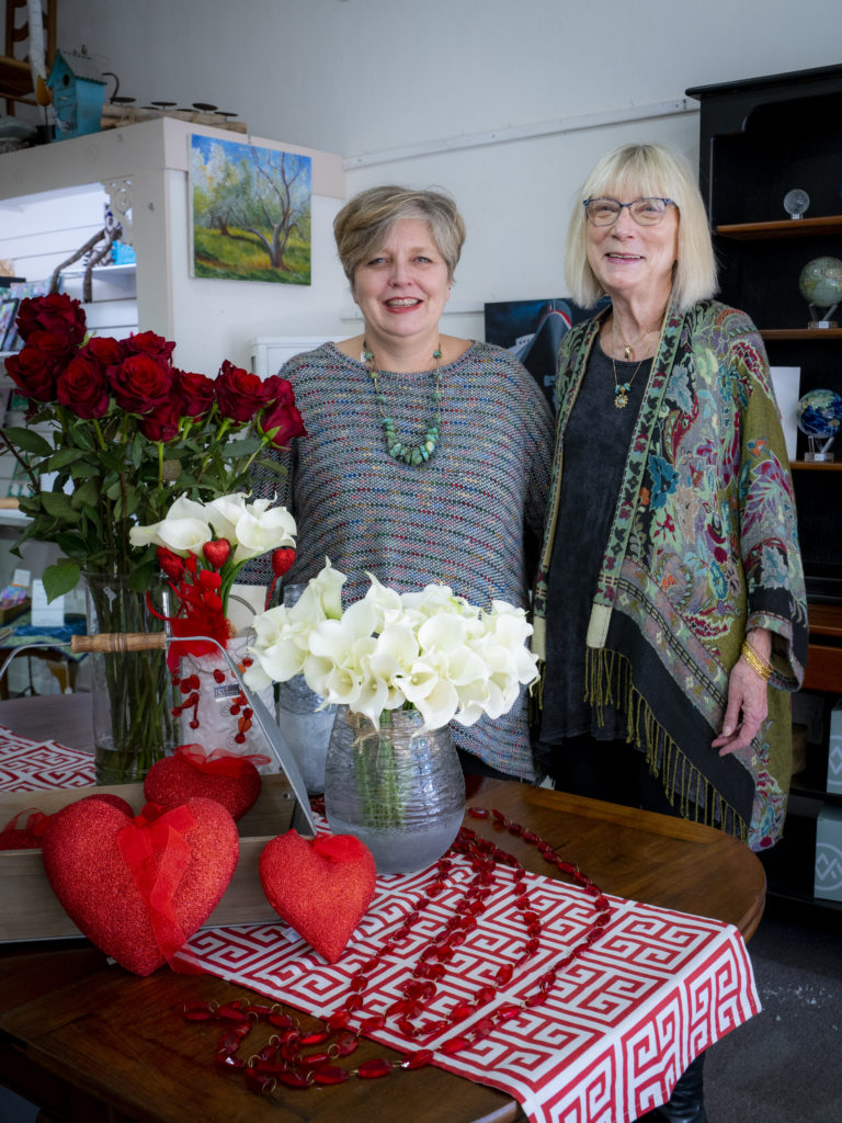 Two women smiling in a flower shop